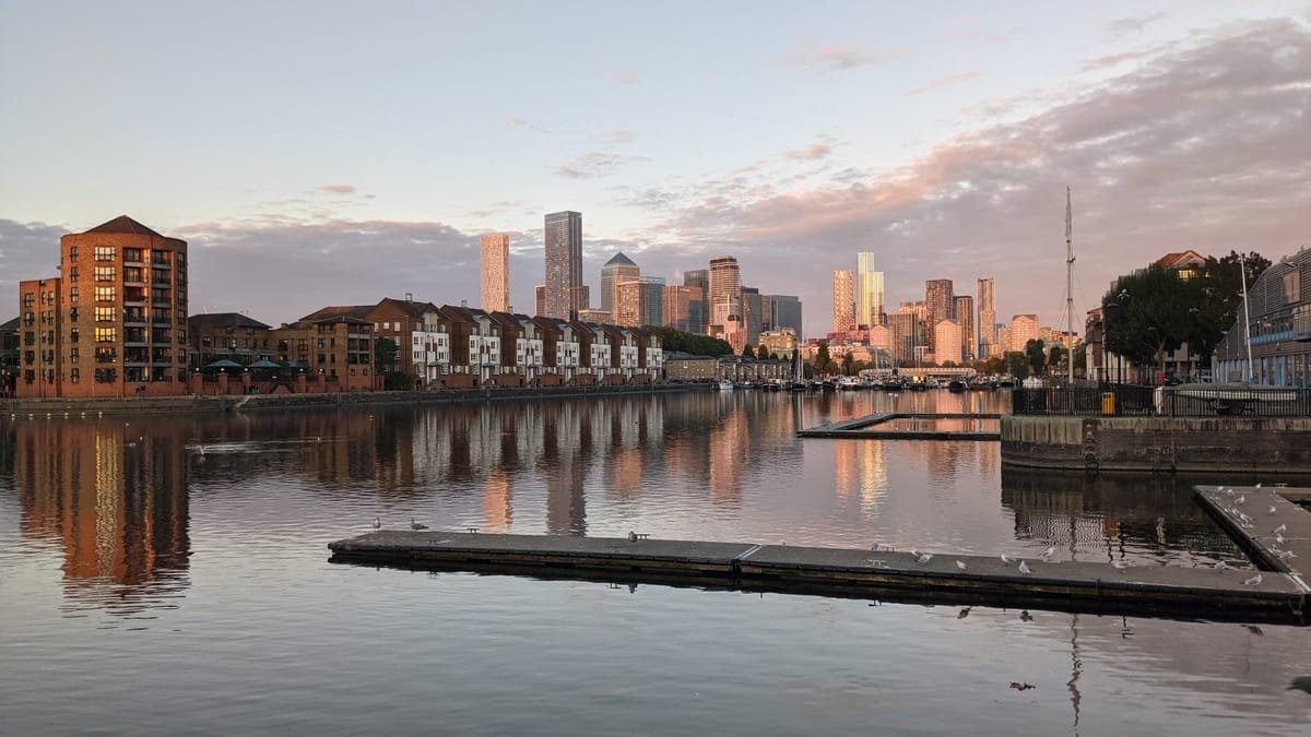 Riverside 1BR — Greenland Dock at sunset, Canary Wharf beyond
